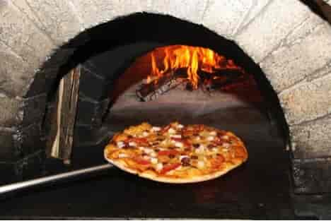 pizza in wood fired stone oven