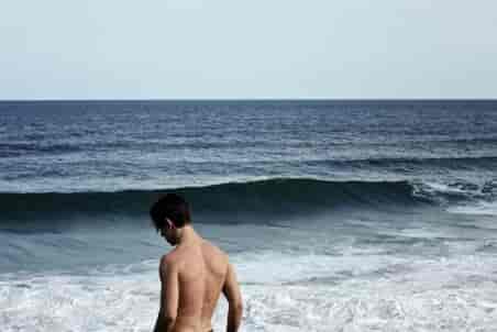 shirtless man on beach